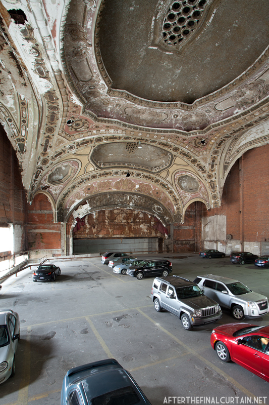 View of the proscenium arch and part of the ceiling from the back of the auditorium.