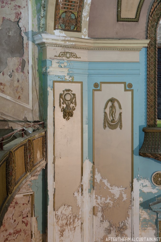 A close up of some plaster work on the side of the auditorium.