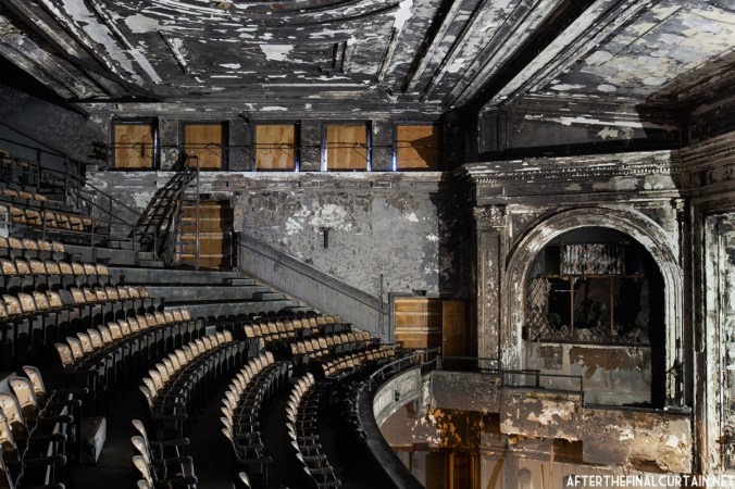 Most of the white paint in the auditorium has turned a greyish black due to the fire damage.
